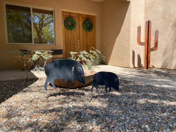 metal javelina family with metal cactus in the background