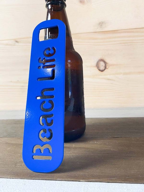 Beach life bottle opener in blue leaned against a bottle