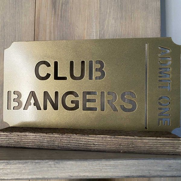 Golden ticket to Club Bangers on a wood shelf