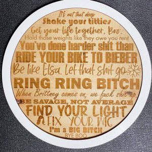 round wood sign with white outside ring, engraved quotes from cody