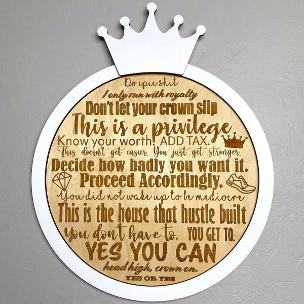 round wood engraved with with white border and crown on top, with robin arzon quotes