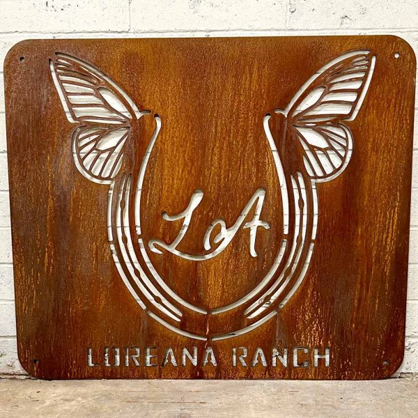 rusted metal ranch sign with butterfly and wings, says Loreana Ranch